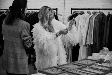 Kate Moss in a white feather jacket and jewelry that was inspired by her travels, and daughter Lila