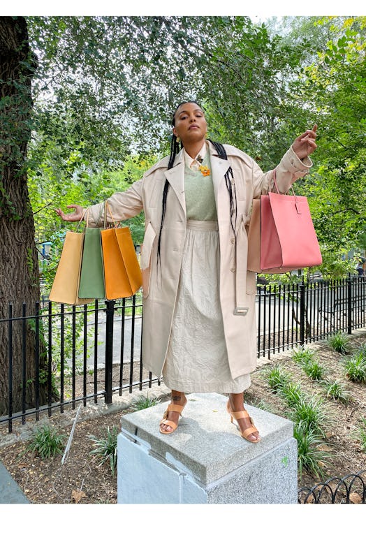 Paloma Elsesser posing with shopping bags for Coach’s “Coach Forever” campaign