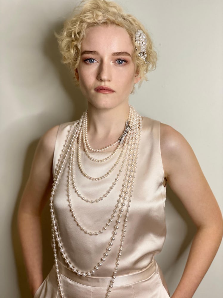 Julia Garner in a beige sating dress and layered pearl necklaces at the 2020 Emmy Awards
