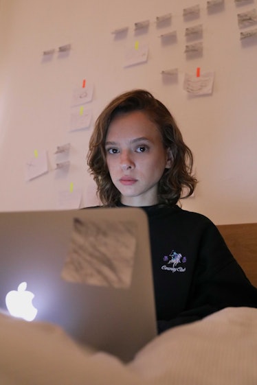 Unorthodox’s Shira Haas sitting and using her laptop