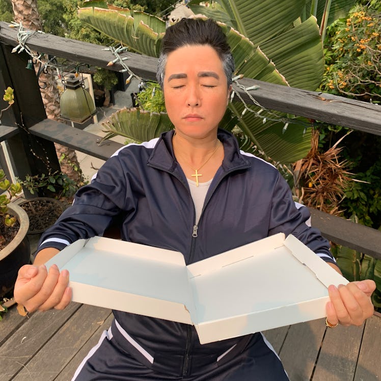 Maya Erskine sitting in a tracksuit with closed eyes and an open book