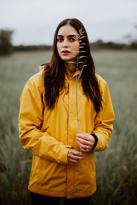 Vida’s Melissa Barrera posing in a yellow jacket