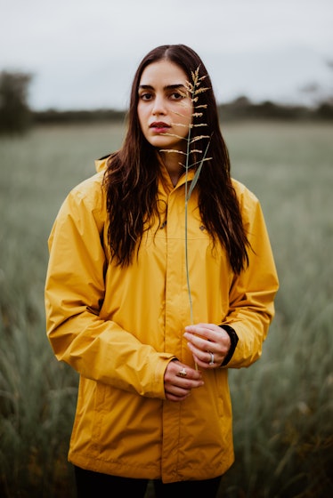 Vida’s Melissa Barrera posing in a yellow jacket