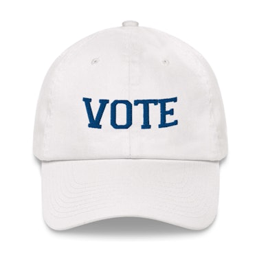 A white Vote Cap with blue embroidered text 'VOTE'