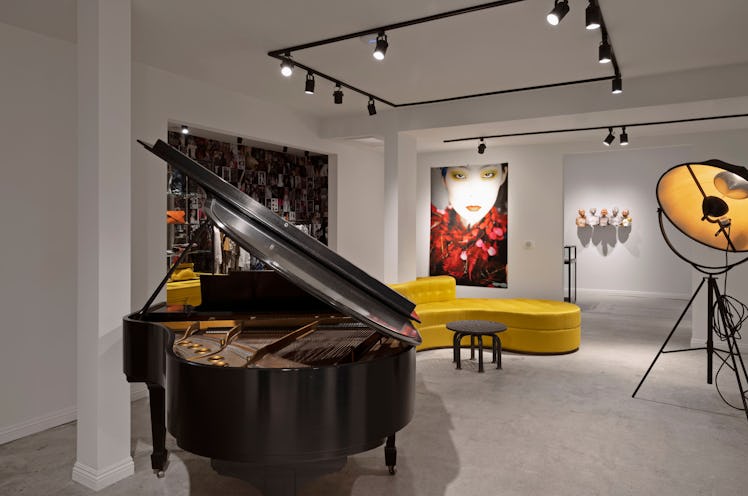 The inside of the Dries Van Noten store with a piano, a yellow couch and ceiling lamps