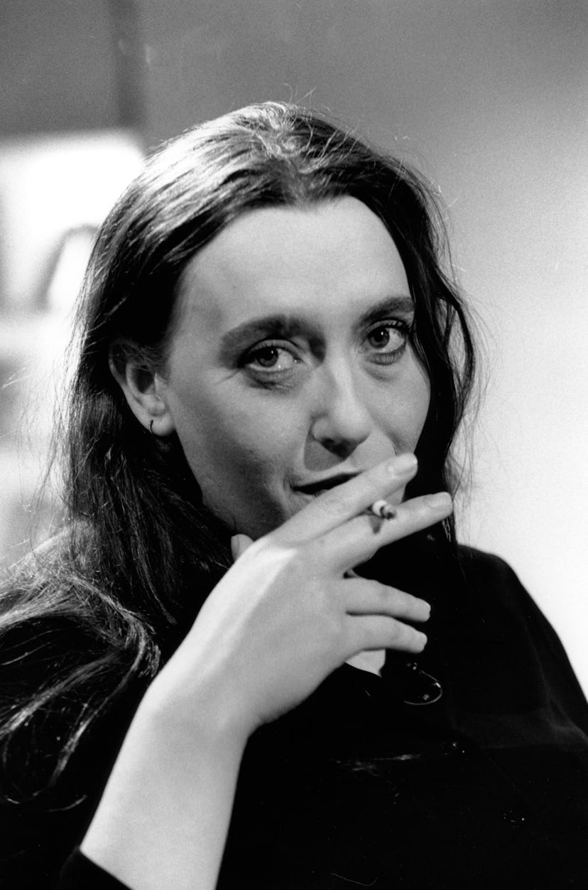 A portrait of Virginie Despentes smoking a cigarette in black-and-white