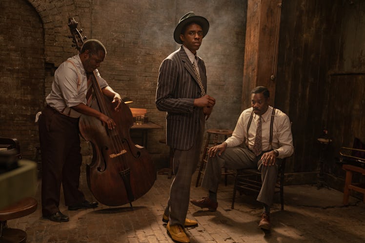Chadwick Boseman in a navy-white striped suit and hat standing in Ma Rainey’s Black Bottom Trailer