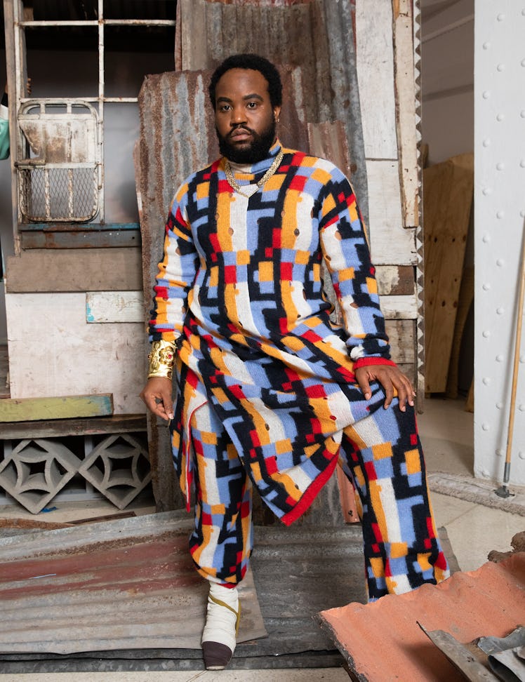 Akeem Smith in a multi-colored sweater and pants inspired by Jamaican Dancehall