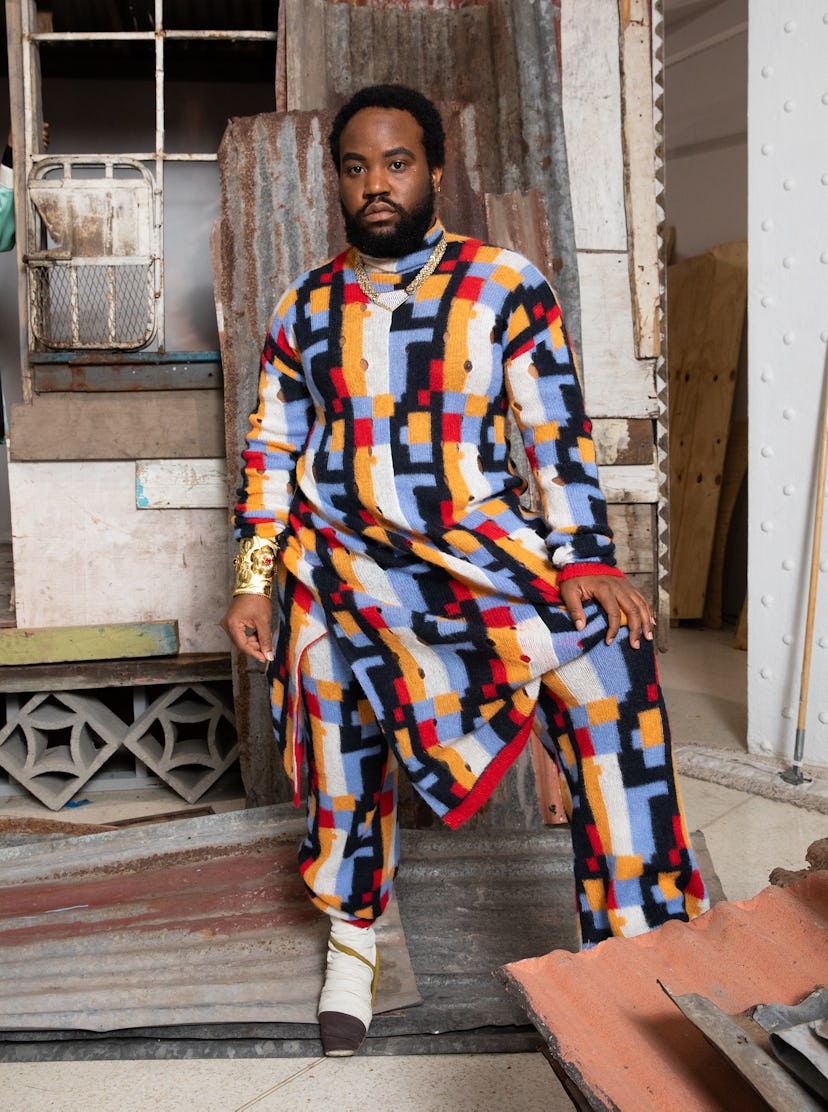 Akeem Smith in a multi-colored sweater and pants inspired by Jamaican Dancehall