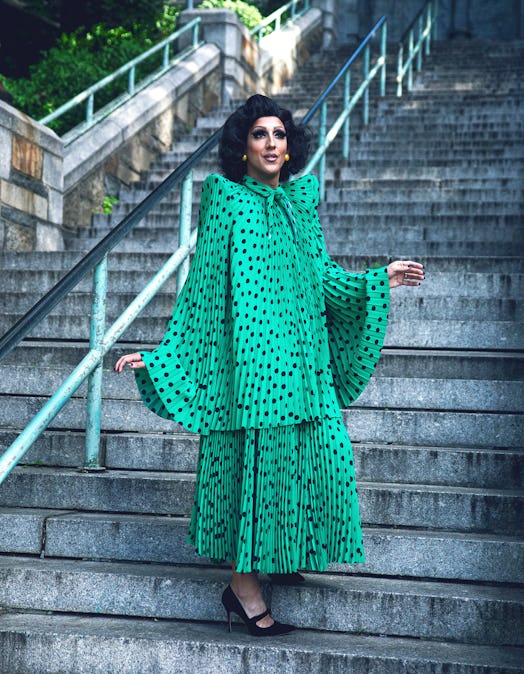 Marti Gould Allen-Cummings posing in a green dress with black dots 
