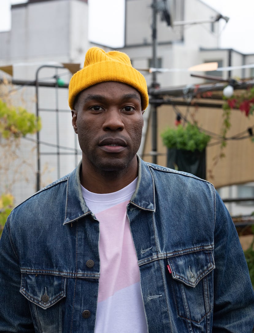 Yahya Abdul-Mateen II in a denim jacket and a yellow beanie