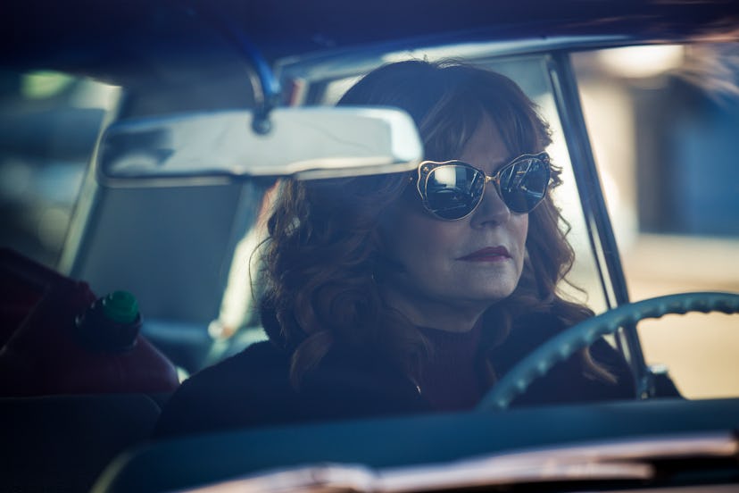 Susan Sarandon driving a car while wearing sunglasses in a Search Party scene