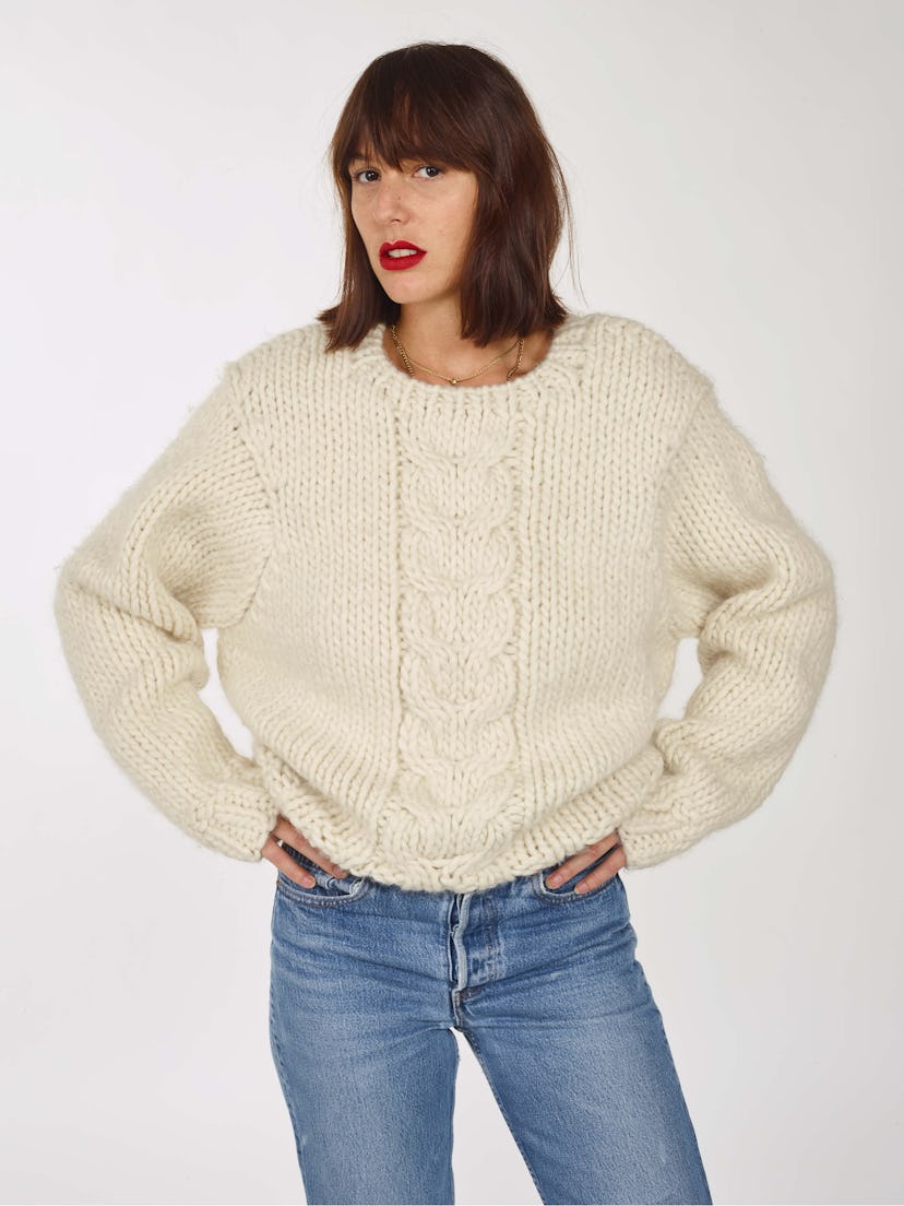 A sweater from knitwear brand Tricot being showcased by a model