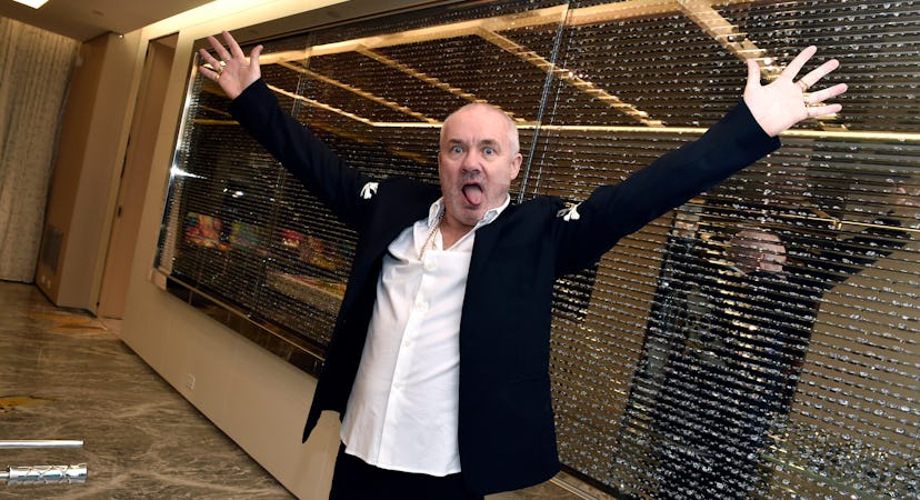 Damien Hirst with his arms outstretched