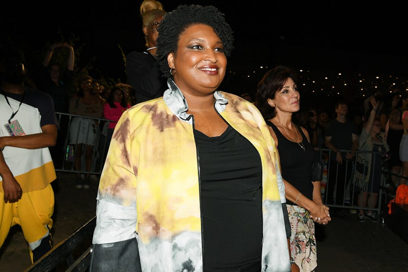 Stacey Abrams in yellow coat.