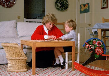 Princess Diana and Prince William working on a puzzle