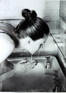 A woman washing her face with clean beauty formulation skincare products