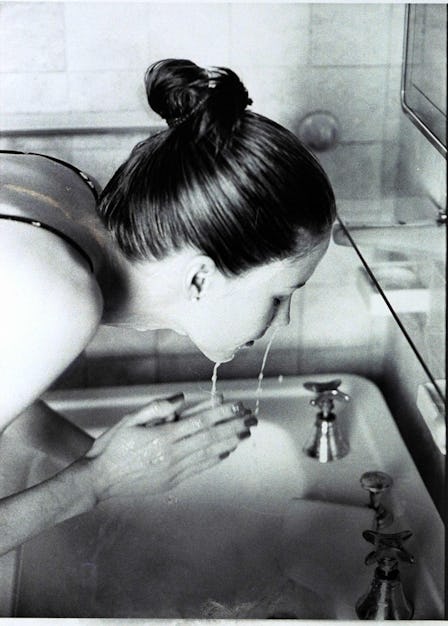 A woman washing her face with clean beauty formulation skincare products