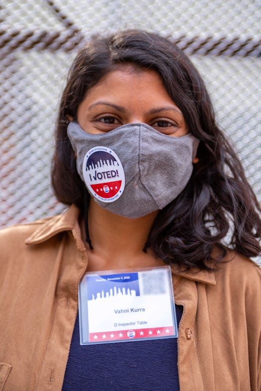 Vahni Kurra, a first-time poll worker, with an "I Voted" sticker on her grey face mask 