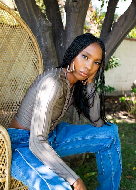 Zerina Akers, the founder of the Black Owned Everything online marketplace posing in a garden