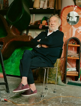 Gaetano Pesce sitting in his studio