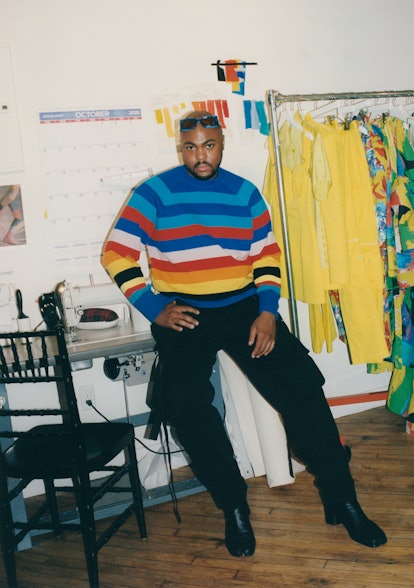 A$AP Rocky posing for a photo in a colorful pullover