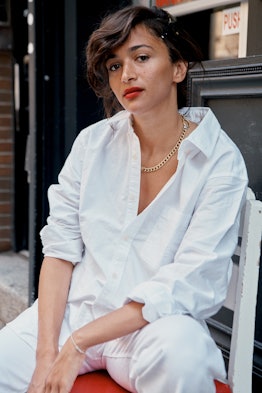 Laila Gohar wearing a white shirt and pants while posing for a photo