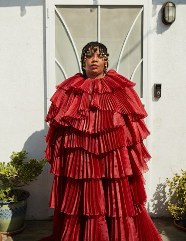 Patrisse Cullors wearing a wide red dress