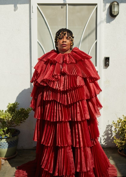 Patrisse Cullors wearing a wide red dress