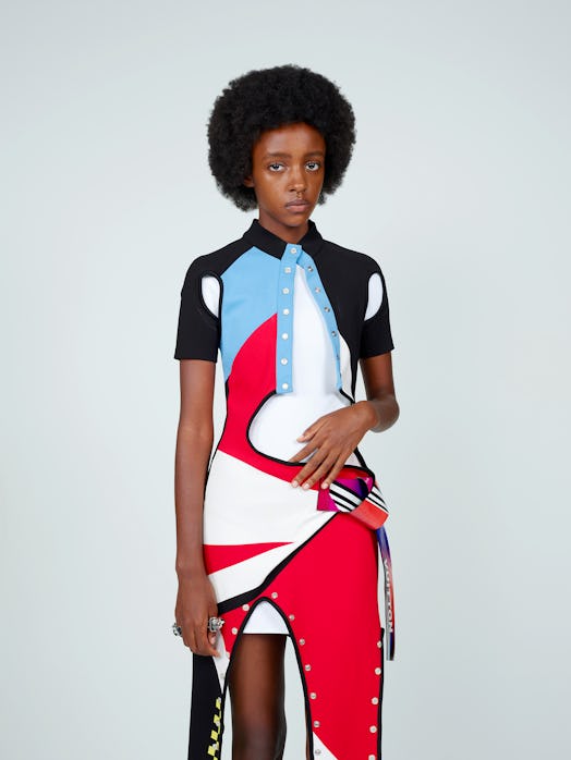 A model wearing a white-black-red-blue abstract-shaped dress