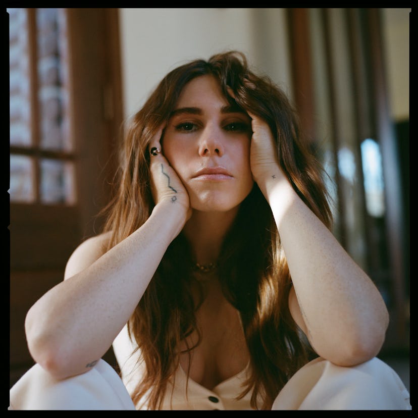 Zosia Mamet posing for a photo while sitting