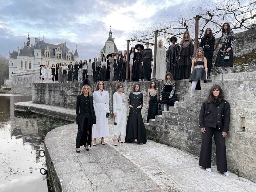 Several models at the Chanel’s Métiers d’Art Show with a castle in the background