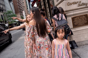 A photo of a mother and two daughters in floral dresses by Melissa O’Shaughnessy in New York City