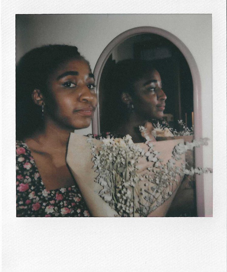 Selfie by Ayo Edebiri in front of a mirror wearing a floral dress