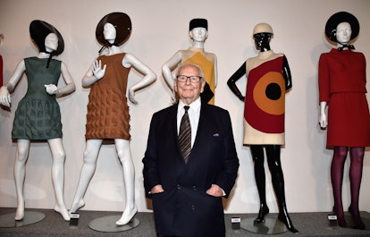 Pierre Cardin in front of his designs.