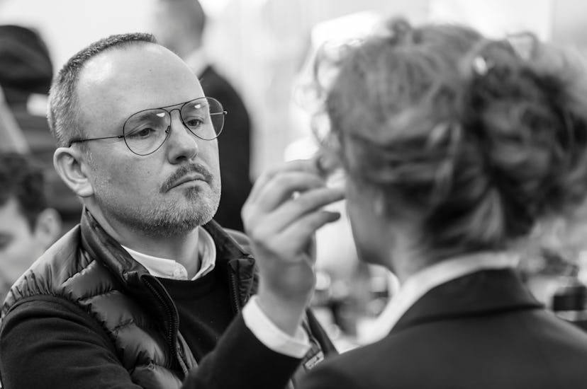 Peter Philips putting makeup on a female model's face