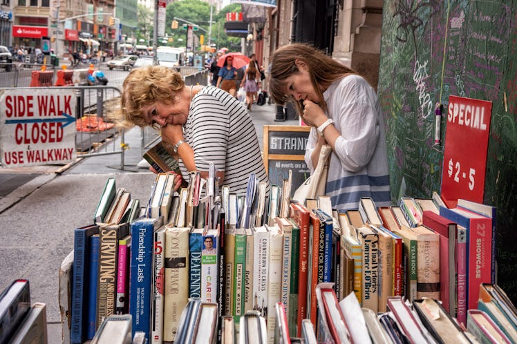 Two women in front of a bookstore by Melissa O’Shaughnessy in New York City