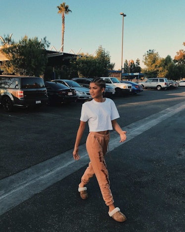 Zendaya passing a parking lot in sweatpants and Ugg Scuff slippers