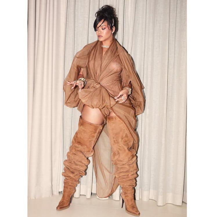 Rihanna wearing a tone-on-tone nude chiffon dress and brown knee high boots