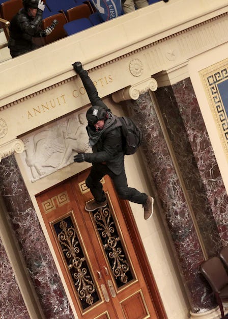 A terrorist scaling the walls of the Capitol