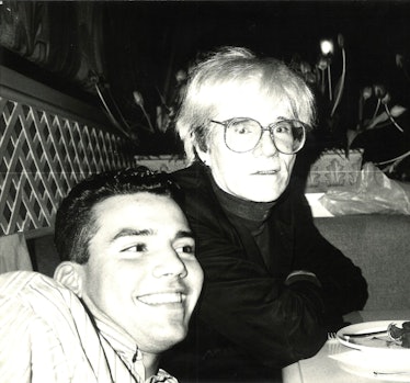 Wilfredo Rosado sitting next to Andy Warhol