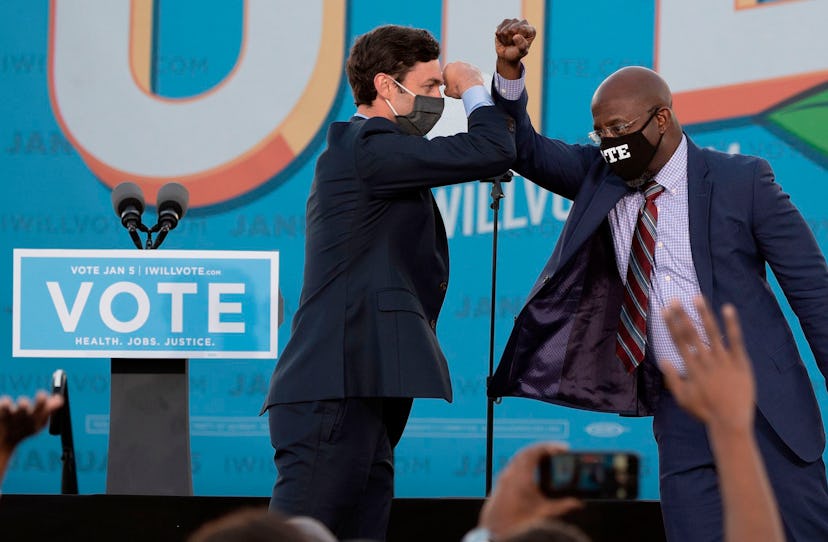 Jon Ossoff and Raphael Warnock bumping elbows