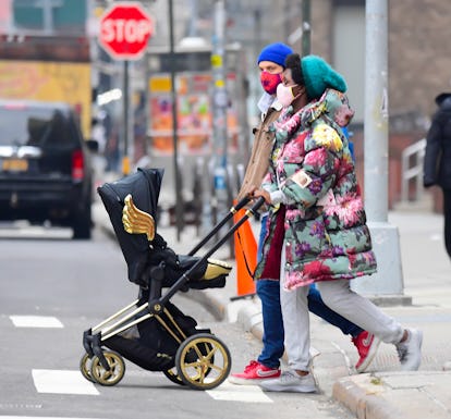 Jodie Turner Smith pushes a pram.