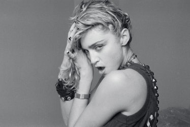 Madonna holding her hair and posing during her ''Like a Virgin'' era
