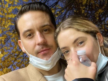 G-Eazy in a beige coat and Ashley Benson in a black jacket with white face masks