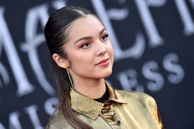 Olivia Rodrigo in a gold shirt.