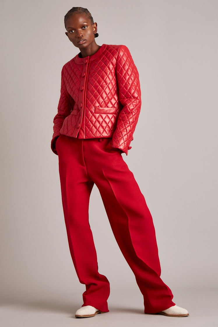 A model in a red coat and red pants by Adam Lippes