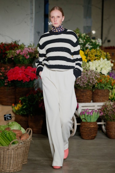 A model walking the New York Fashion Week runway for Jason Wu in a striped sweater and wide white pa...