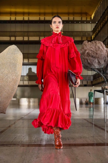 A model in a long red dress with ruffles and a bow on the neck by Ulla Johnson