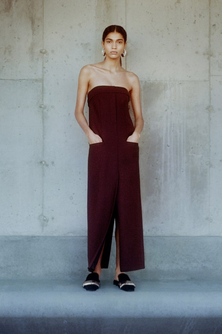 A model in a maroon strapless jumpsuit by Proenza Schouler